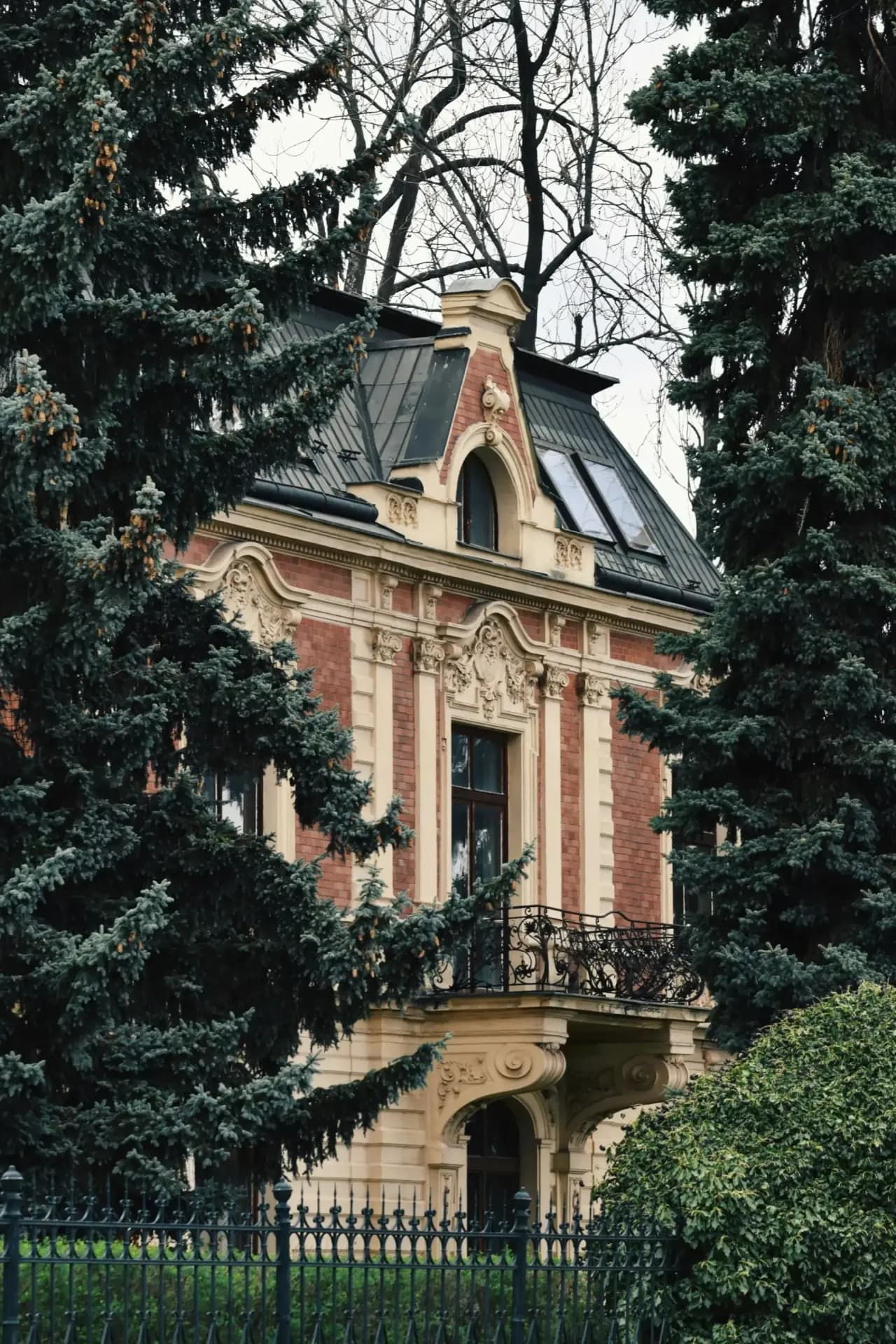 European-style luxury villa exterior with French architectural details and mansard roof