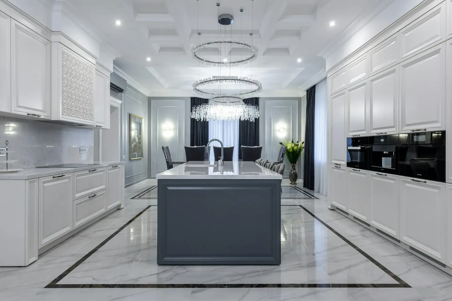 Grand Kitchen with Chandeliers White luxury kitchen with crystal ring chandeliers and marble flooring